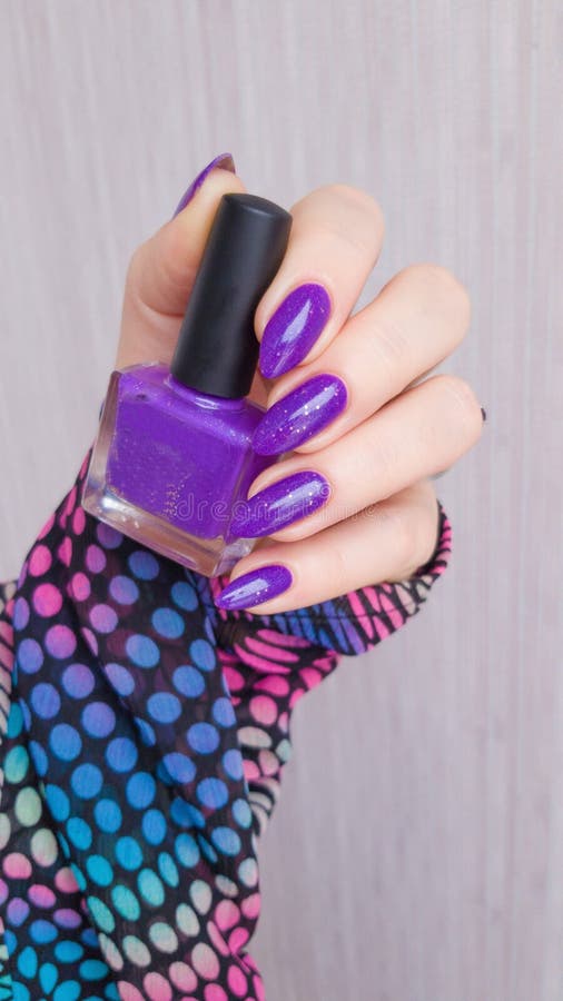 Female Hand with Purple Long Nails and Nail Polish Bottle Stock Image ...