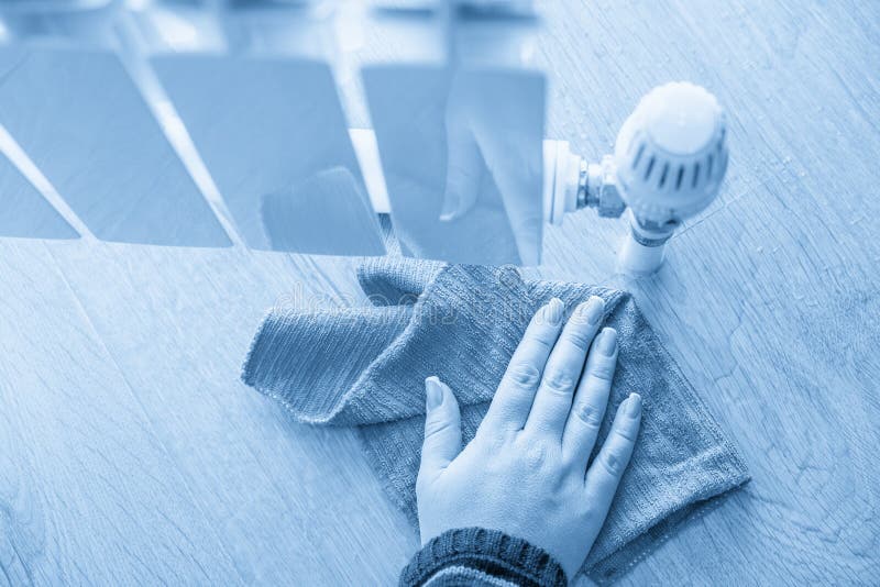 Female Hand with Rag Cleaning Water from Heating Radiator Leak Stock