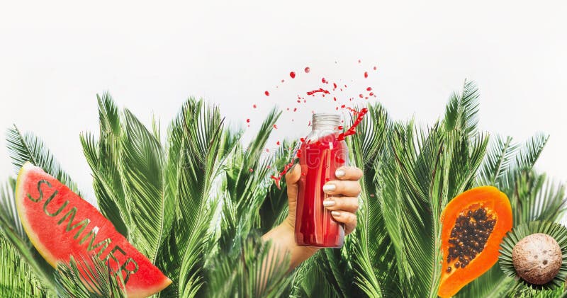 Female hand with red drink bottle: juice or smoothie leaned out of jungle  with fruits , coconut and water melon with text summer