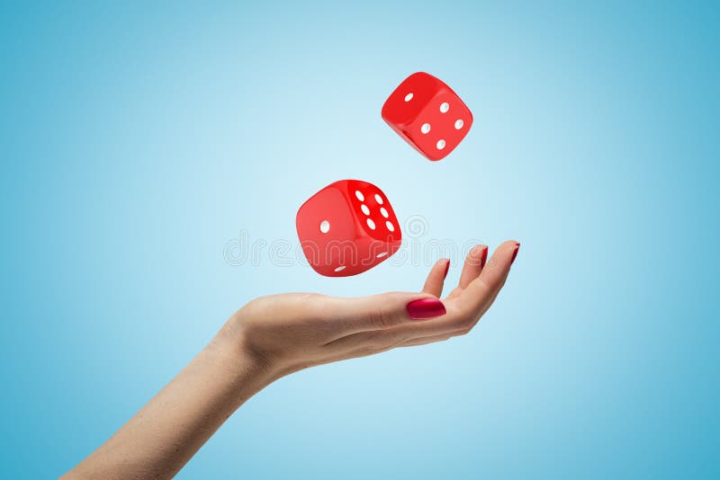 Female hand throwing two red casino dice up in the air on blue background. 