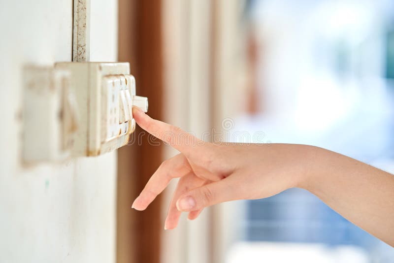 Woman turning on left signal switch, close up shot of her hand