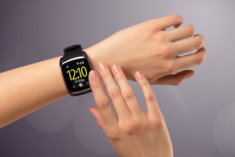 Female hand wearing and pressing smartwatch