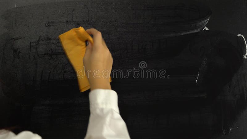 Female hand wipes the board with formulas