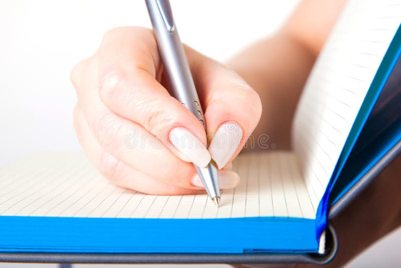 Female hand writing in a notebook