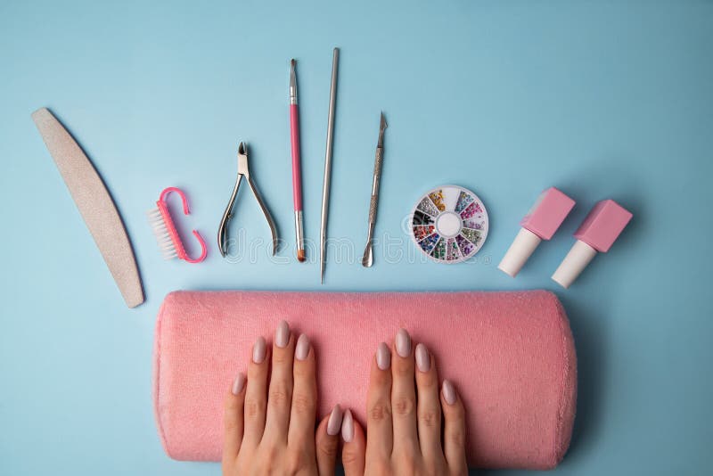 Female Hands with Beautiful Manicure and Manicure Accessories on a Blue ...