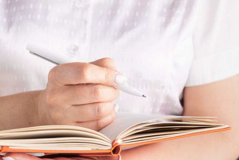 Female hands a close up writing in the daily log stock images Female hands a close up writing in the daily log stock images