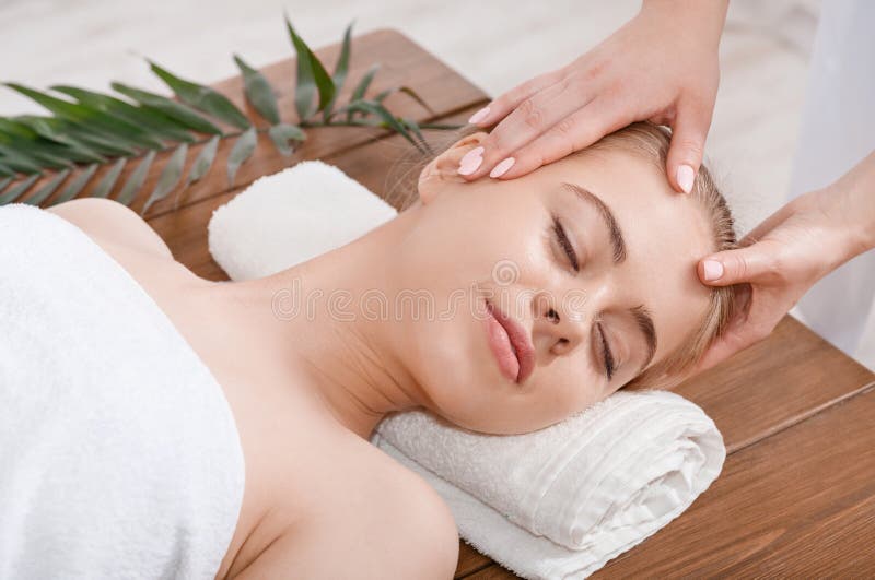 Female Hands Do Rejuvenating Face Massage For Woman On Table With Palm Leaf Stock Image Image