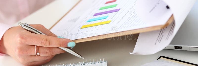 Female Hands Hold Silver Pen And Pad