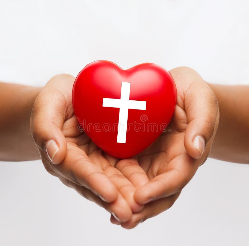 Female hands holding heart with cross symbol