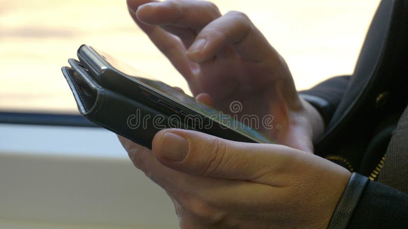Female hands holding phone on train stock video footage