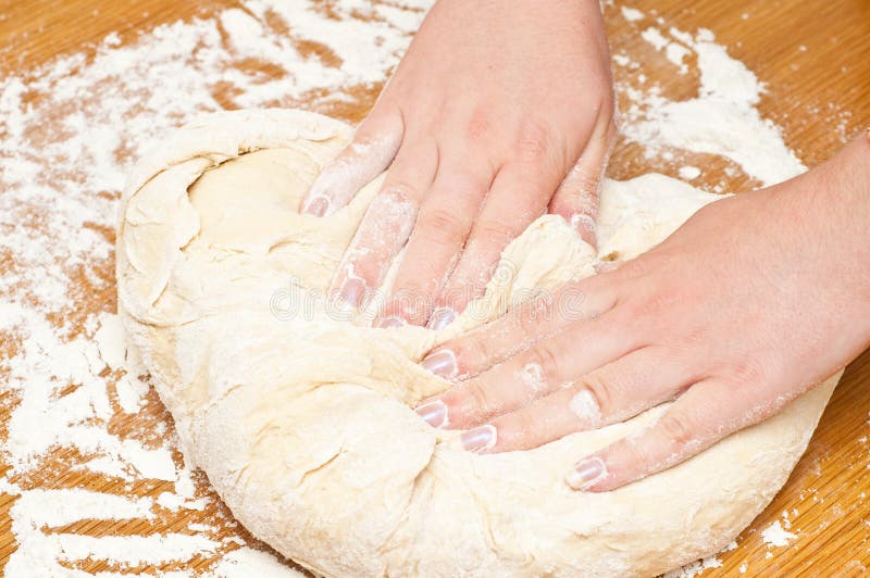 Female hands kneading dough royalty free stock photo