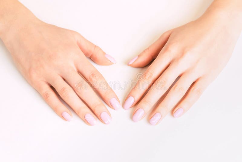 Female hands with manicure and pink pastel color polish. stock photo Female hands with manicure and pink pastel color polish. stock photo