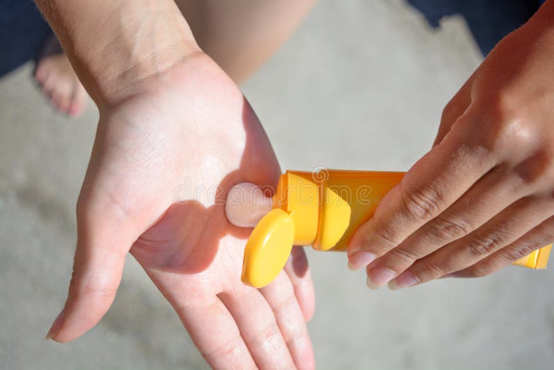 Female hands with sun protection cream. Skin care