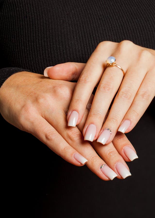 Female hands with tender pink manicure, close-up. Beauty and fashion. Hand and nail care.