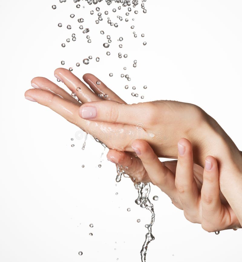 Female hands under the falling drops of water