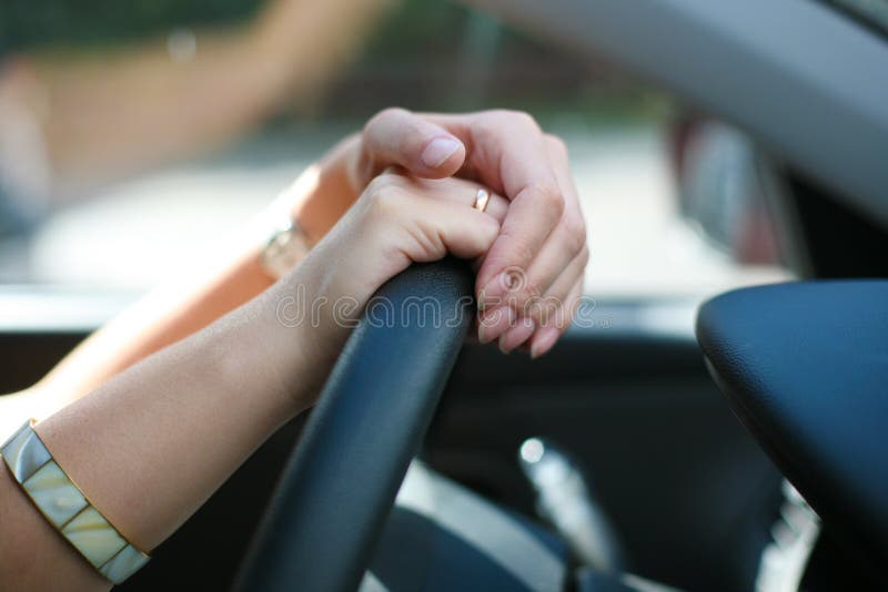 Female hands on wheel