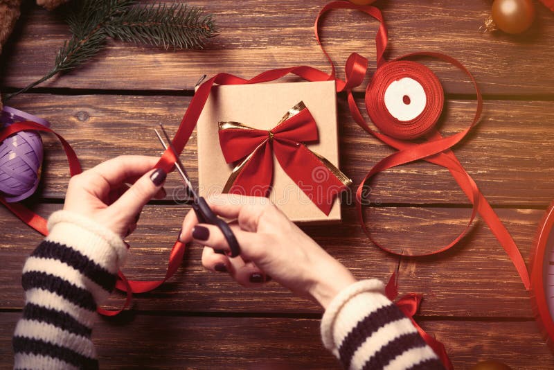 Female hands wrapping a gift