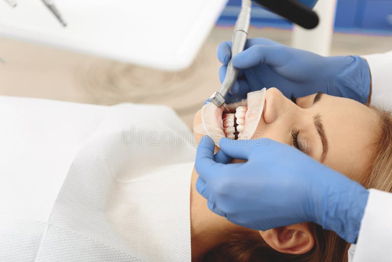 Female having teeth treatment at stomatological clinic