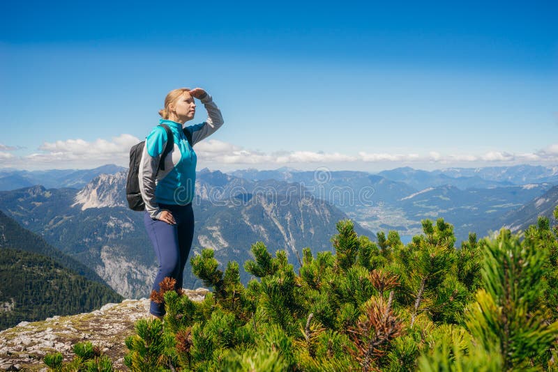 Female hiker on the edge of hill looking at view royalty free stock photography Female hiker on the edge of hill looking at view royalty free stock photography