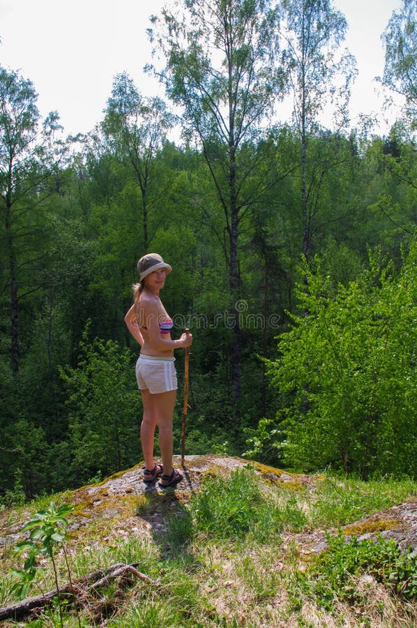 Female hiker standing on rocky trail and waching azure amazing colors mountain forest lake background royalty free stock photography Female hiker standing on rocky trail and waching azure amazing colors mountain forest lake background royalty free stock photography