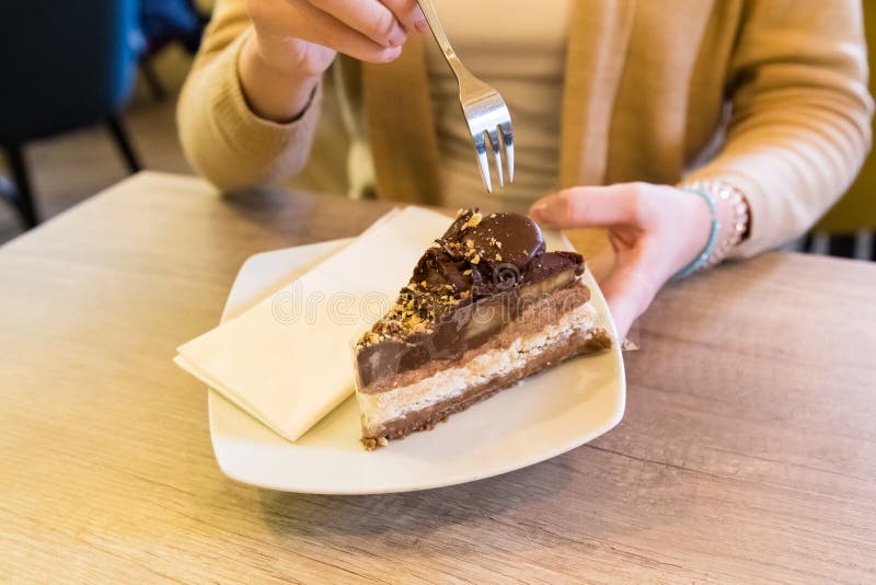 Female holding a fork and plate with piece of homemade chocolate royalty free stock photos Female holding a fork and plate with piece of homemade chocolate royalty free stock photos
