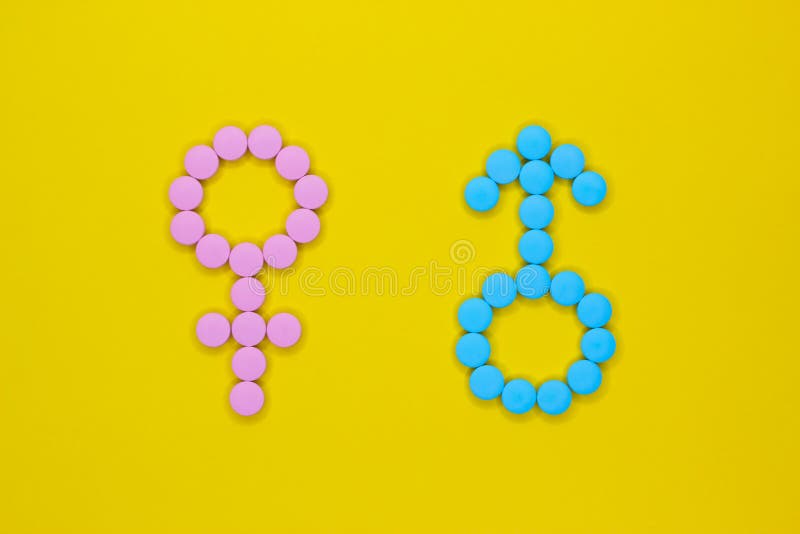 Female hormones estrogen: estradiol, estriol and progesterone and male hormone testosterone. Gender signs from pills on yellow background. Top view.