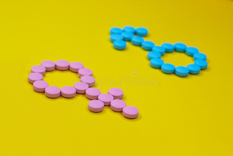 Female hormones estrogen: estradiol, estriol and progesterone and male hormone testosterone. Gender signs from pills on yellow background. Top view.