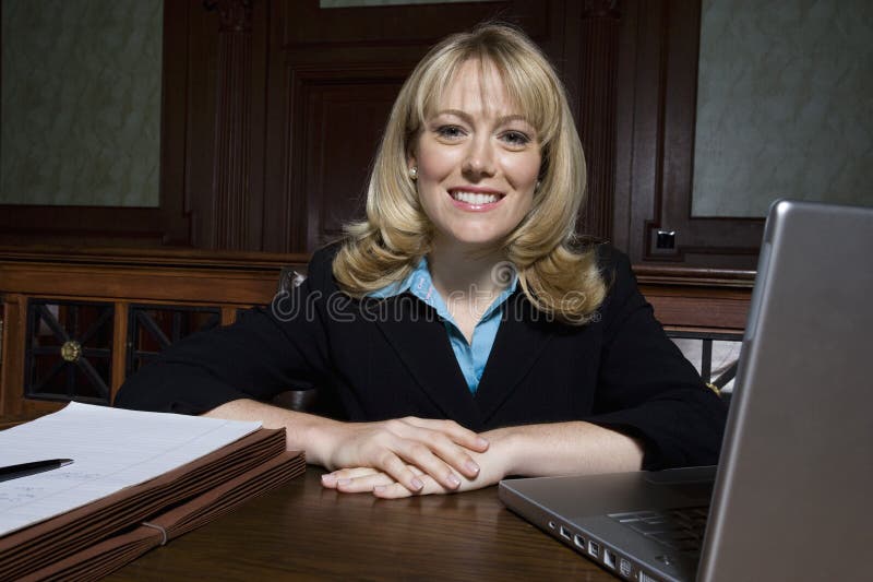 Female Lawyer Sitting With Laptop And Documents