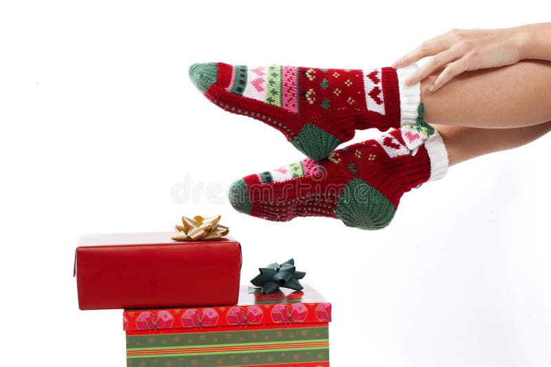 Female legs in christmas stockings isolated on whi