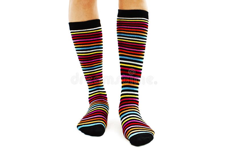Female legs in colorful striped socks royalty free stock image