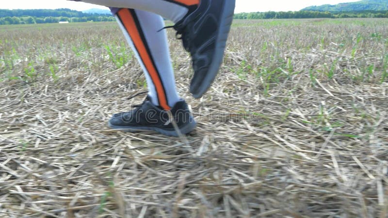 Female legs in compression running socks. Woman in sportswear running