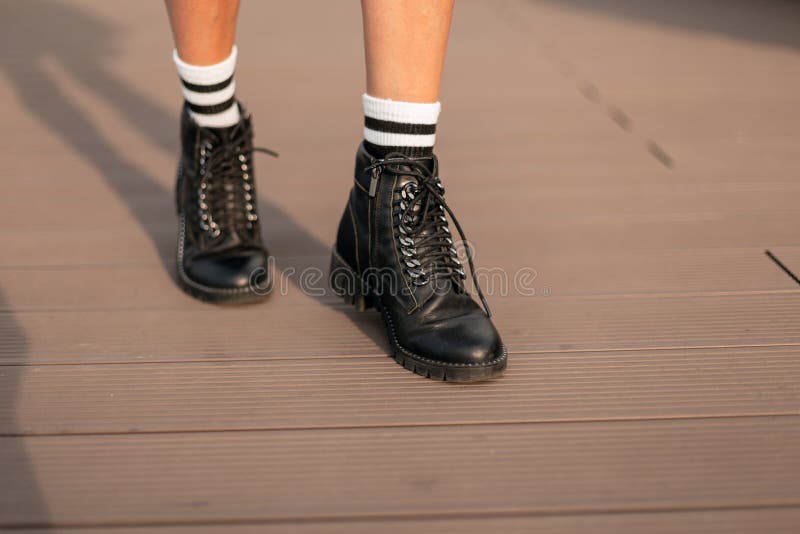 Female Legs in Fashionable Leather Black Boots in Stylish White Striped  Socks. Trendy Youth Casual Outfit Stock Image - Image of lady, city:  160729683