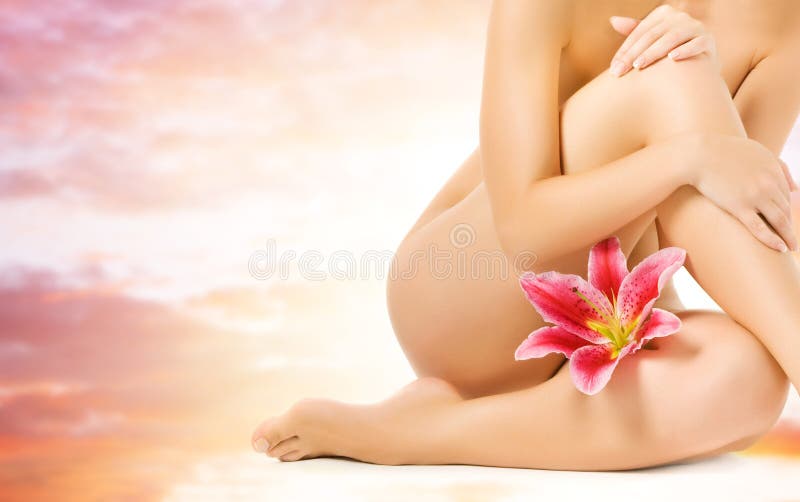 Female legs with pink lily royalty free stock photography
