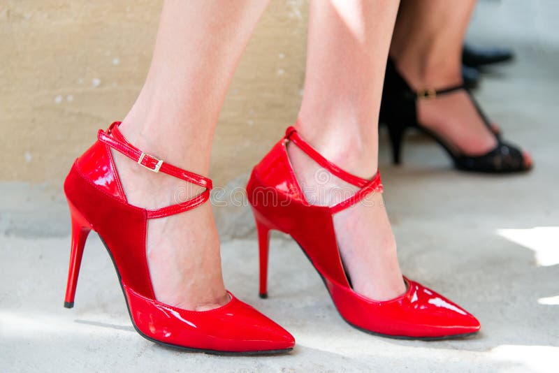 Female Legs in Red Shoes Against the Confetti and Garlands Stock Image ...