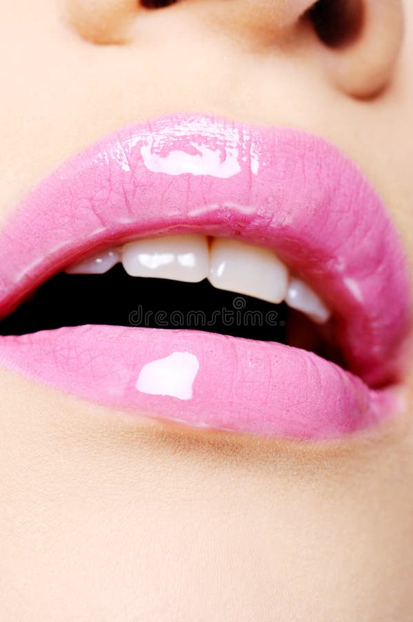 Female lips with bright pink lipstick stock photo