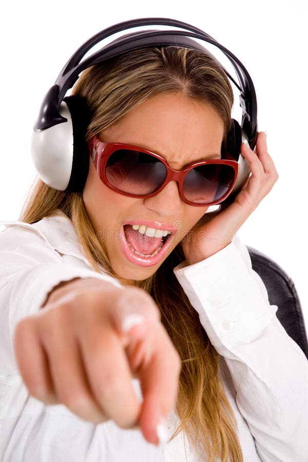 Female listening music and pointing at camer