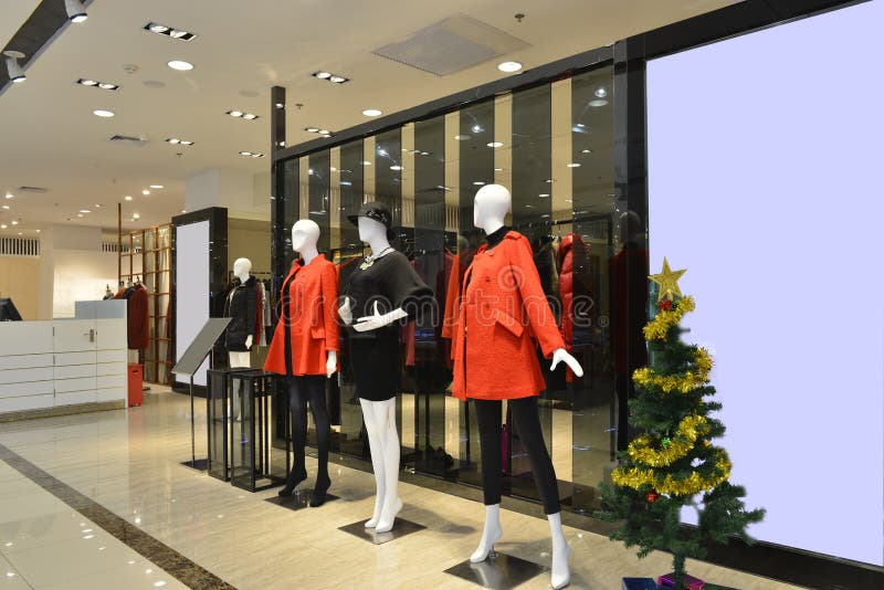 Interior view of a fashion shop hall,Hongkong,China,Asia. Red and black dress ,Various styles of clothing hanging on racks. Interior view of a fashion shop hall,Hongkong,China,Asia. Red and black dress ,Various styles of clothing hanging on racks