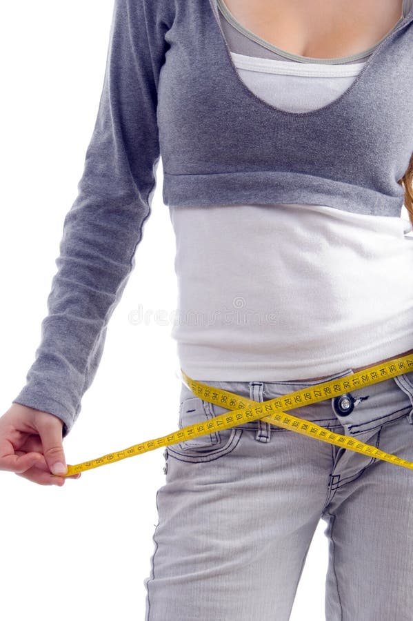 Female measuring her waist with tape