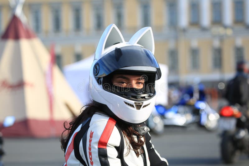 Female motorbiker in an anime cat helmet looking at the camera stock images Female motorbiker in an anime cat helmet looking at the camera stock images