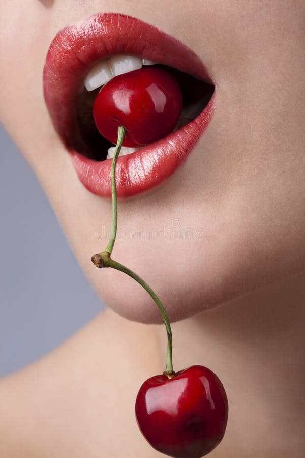 Female mouth with cherries