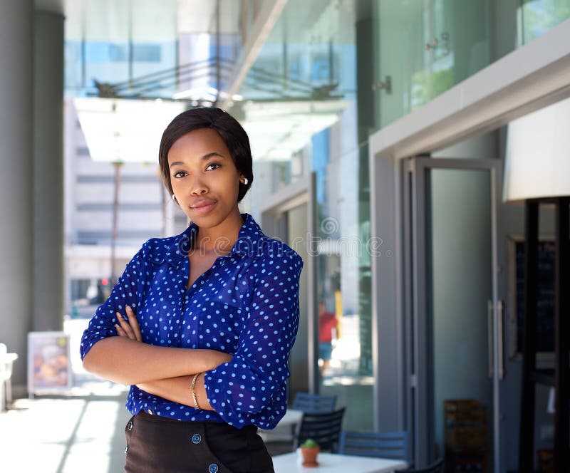 Female office worker standing outside business building