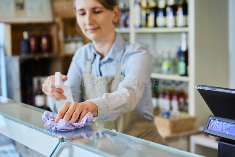 https://thumbs.dreamstime.com/b/female-owner-delicatessen-cleaning-counter-sanitising-spray-216231830.jpg