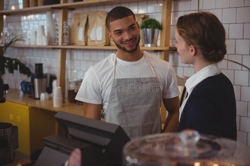 Owner talking with waiter in cafe stock photography Owner talking with waiter in cafe stock photography