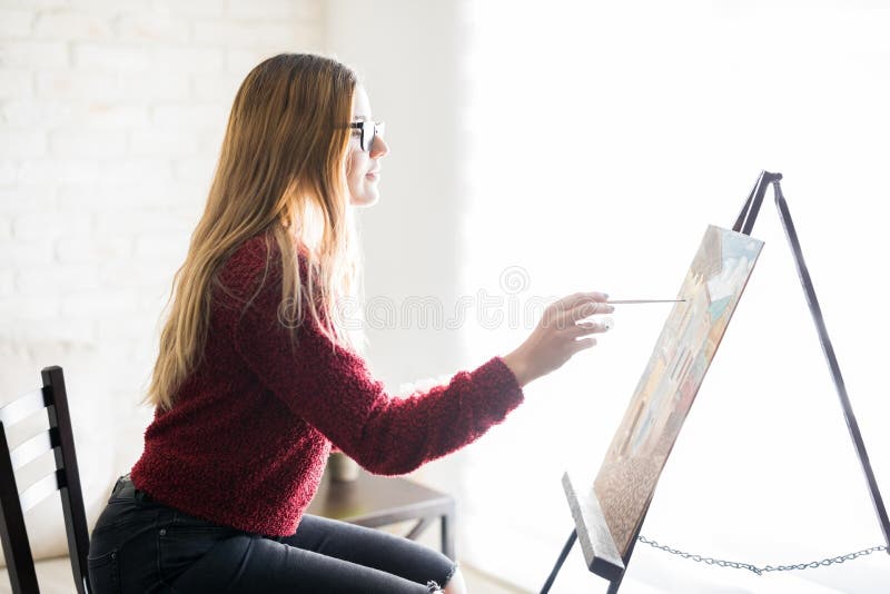 Profile Of A Painter Drawing A Sketch Of A Young Woman Stock Photo