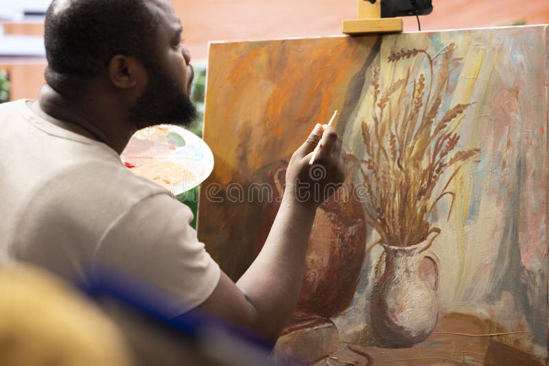Female painter takes notes and teaches the art of painting in atelier royalty free stock photo
