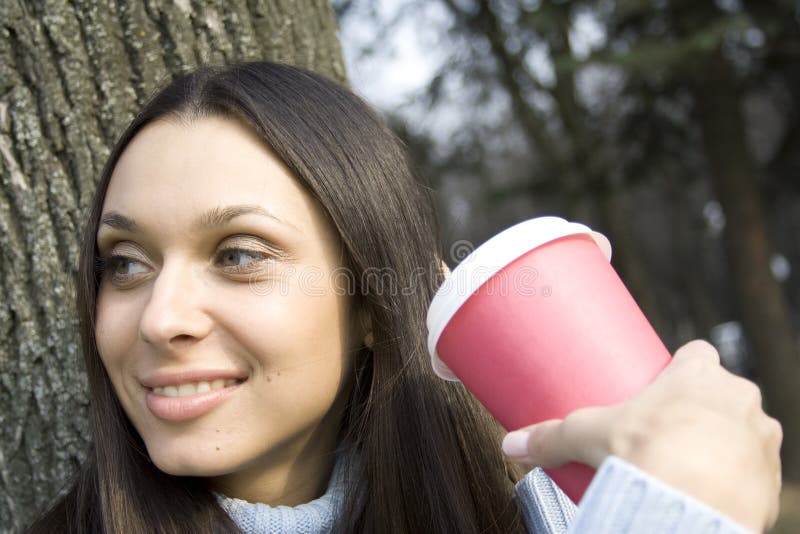 Female in a park drinking coffee