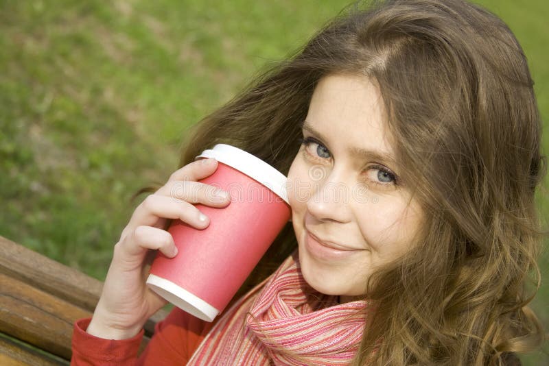 Female in a park drinking coffee