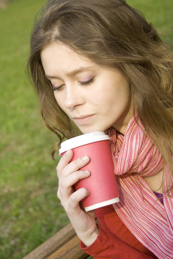 Female in a park drinking coffee