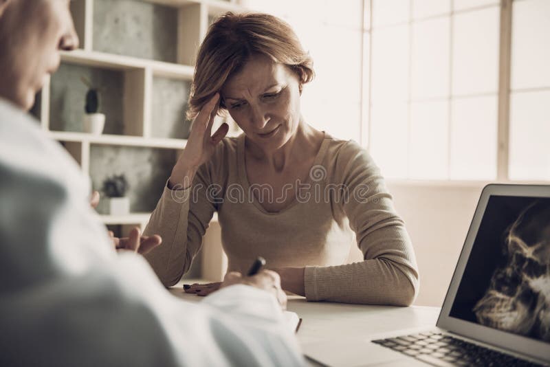 Female Patient with Ache at Doctor`s Appointment royalty free stock photography Female Patient with Ache at Doctor`s Appointment royalty free stock photography