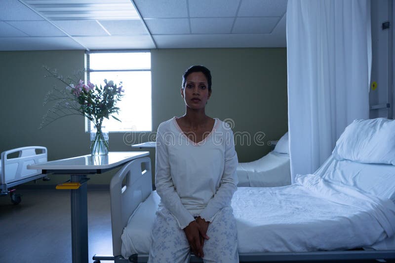 Female patient looking at camera while sitting on bed royalty free stock photos Female patient looking at camera while sitting on bed royalty free stock photos